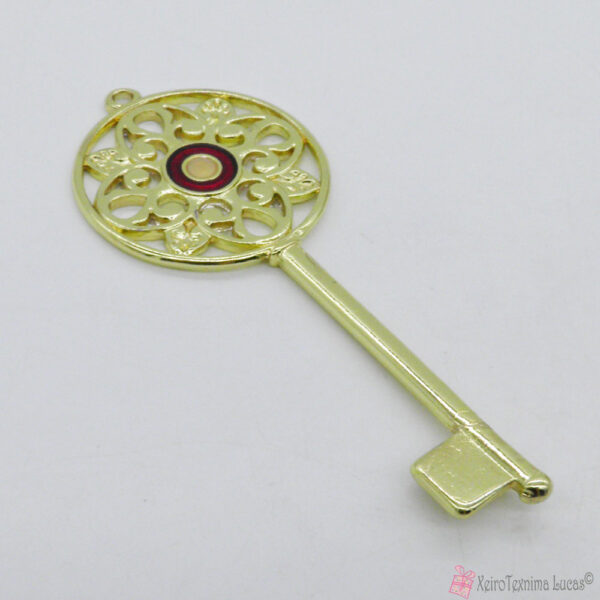 Χρυσό μεταλλικό κλειδί με μπορντό μάτι σμάλτο